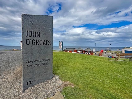 Stone with quote at sea view and green lawn in John O'Groats, Scotland, Great Britain
