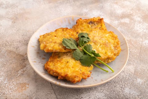 Fried crispy Chicken pancakes on brown concrete background. side view, close up