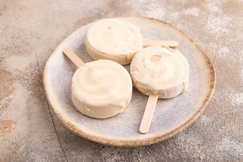 ?hocolate Ice cream in white glaze, on brown concrete background, side view, close up, minimalism