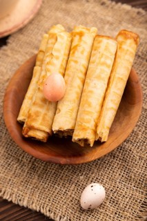 Waffles with caramel on brown wooden background and linen textile, cup of coffee, side view,