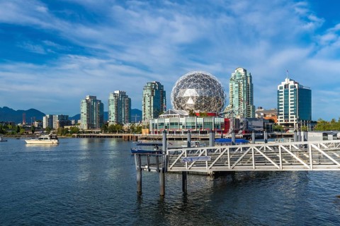 Modern buildings and science world are reflecting in the calm waters of false creek, vancouver,