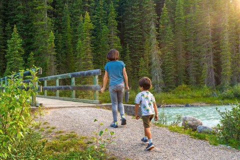 Mother and son enjoying a leisurely hike along a scenic banff national park trail, surrounded by