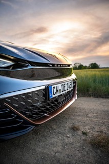 Close-up of the front of a car with sunset in the background, Deer e-car sharing, Cupra electric