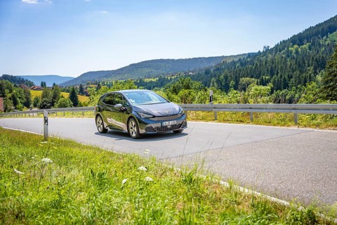 Car driving on a winding road in a mountainous landscape, Deer E-car sharing, Cupra electric car,
