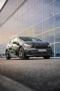 Car in front of a large glass façade of a modern office building, Deer E-Car Sharing, Cupra