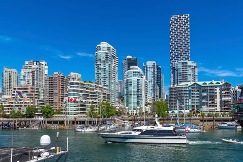 Modern skyline of vancouver. British columbia. With high rise residential buildings and a motorboat
