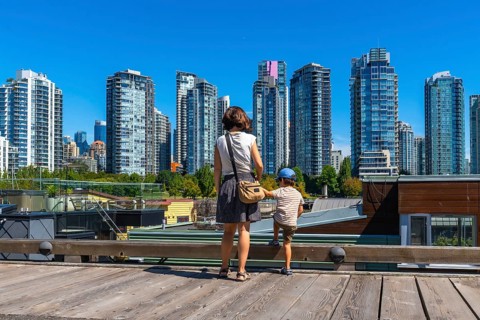 Mother and her son are enjoying the breathtaking view of the vancouver skyline, with its modern