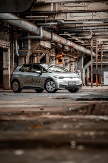 A vehicle is parked in an old factory with an industrial, raw character, Deer E-Car Sharing,