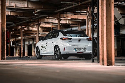 Rear view of a white car sharing car in an urban industrial building, Deer E-Car Sharing,