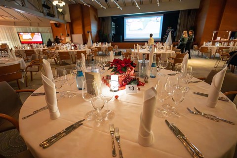 A festively decorated table with Christmas decoration and elegant lighting, Christmas party Dekra