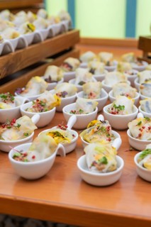 Various small bowls of dim sum arranged on a wooden table, Christmas party Dekra Congresshotel