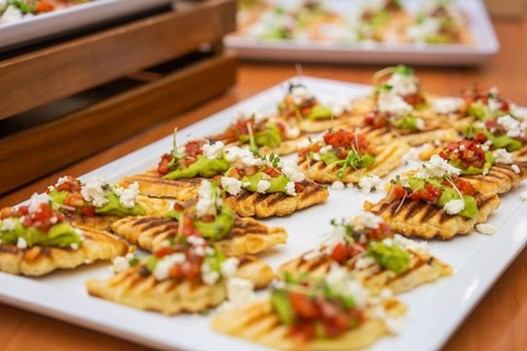 Delicious gaufres with avocado and tomatoes served stylishly piece by piece, Christmas party Dekra