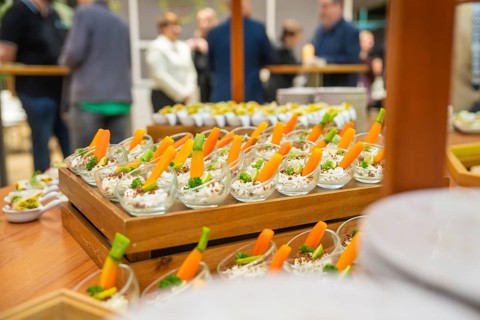 Freshly cut carrots displayed in attractive small glasses, Christmas party Dekra Congresshotel