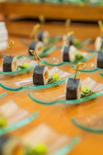 Small sushi appetizers artfully arranged on glass plates ready for reception, Christmas party Dekra