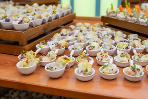 Bowls with delicious starters and colorful side dishes presented decoratively, Christmas party