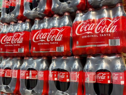 0.5 half liter plastic PET bottles stacked in plastic packs with sugary caffeinated beverage soft
