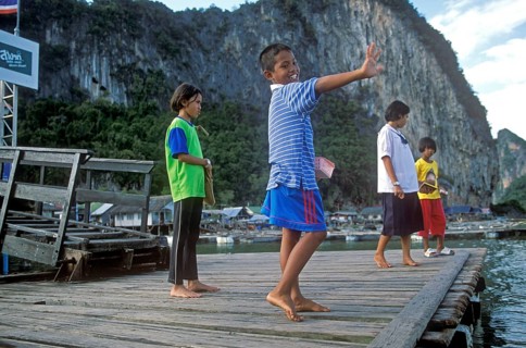 Children, little boy waving in the stilt village of Ko Pannyi in Phangnga Bay near Ko Phuket, two