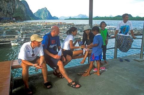 Young boy in the stilt village of Ko Pannyi in Phangnga Bay near Ko Phuket selling souvenirs to