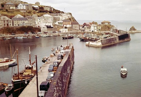 Boats at moorings in the harbour at seaside fishing village of Mevagissey, Cornwall, England, UK c