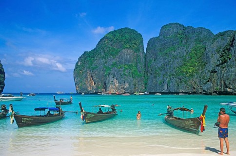People, longtail boats on Maya Bay beach, known from the movie The Beach, one year in front of the