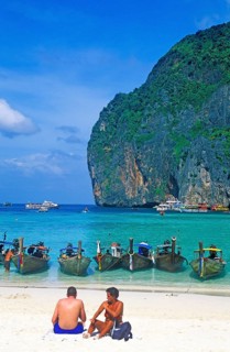 People, longtail boats on Maya Bay beach, known from the movie The Beach, one year in front of the