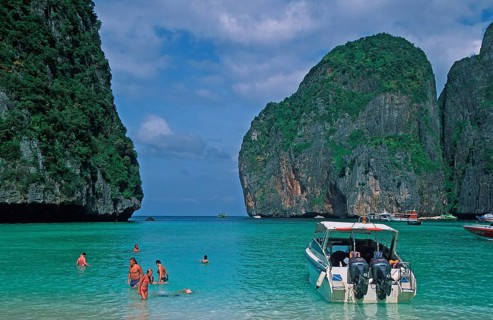 People, boats on Maya Bay beach, known from the movie The Beach, one year in front of the tsunami,