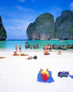 People and longtail boats on Maya Bay beach, known from the movie The Beach, one year in front of