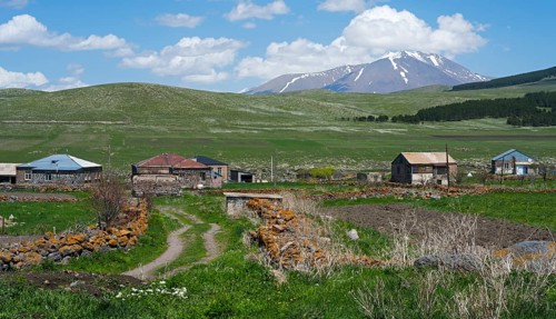 Dirt roads in a village with mountain views and snowy peaks in the distance, Jigrasheni, Didi Abuli
