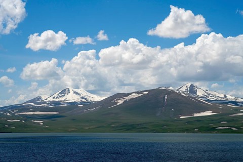 Majestic snow-capped mountains above a deep blue lake, Lake Parawani, Samtskhe—Javakheti Highlands,