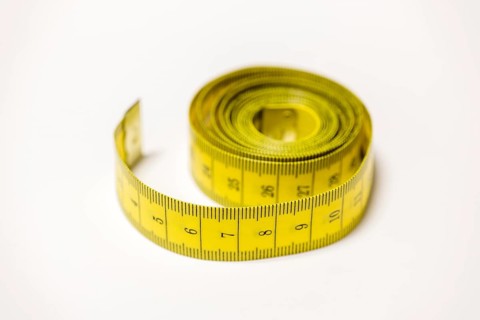 Rolled yellow tape measure that enables accurate measurements, Germany