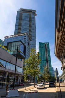 Sunlight illuminating modern skyscrapers and street view in downtown vancouver, british columbia,