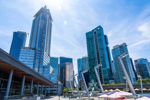 Glass skyscrapers and modern architecture dominate the skyline of vancouver, british columbia, on a