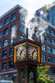 Rising steam from the gastown steam clock, a captivating vancouver landmark, contrasts with modern