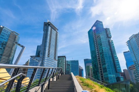 Modern skyscrapers dominate the skyline of vancouver, british columbia, seen from a low angle