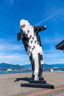 Pixelated orca sculpture overlooking the scenic waterfront in vancouver, british columbia,
