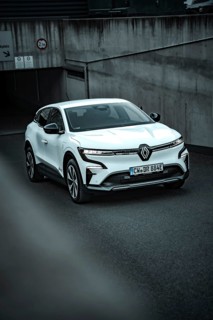 White modern SUV drives out of an underground car park on asphalt ground, Deer E-Carsharing,
