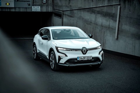 White modern SUV drives out of an underground car park on asphalt ground, Deer E-Carsharing,