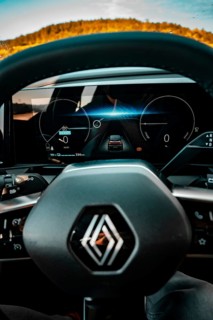 Interior view of an electric car with display and steering wheel, blue light section, Deer