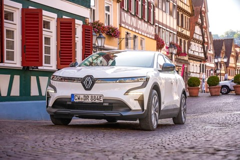 White car in picturesque old town with half-timbered houses and floral decorations, Deer