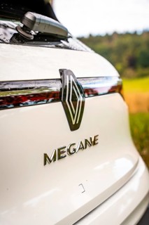 Rear of a white Renault Megane with logo against a natural backdrop, Deer e-Carsharing, Renault