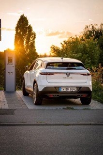 A car charges at a station, illuminated by the warm shade of sunset, Deer E-Carsharing, Renault