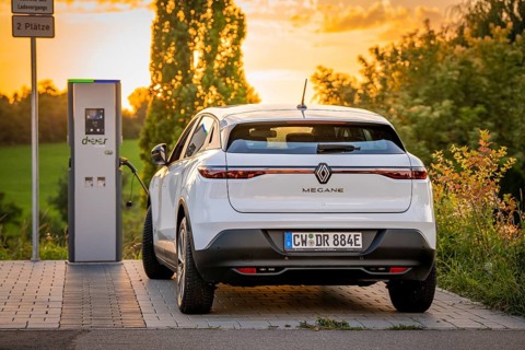 An electric car parks peacefully at a charging station in the evening light, Deer E-Carsharing,