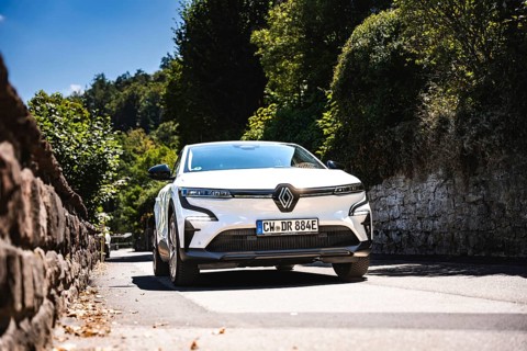 White car driving down a tree-lined stone road, Deer E-Carsharing, Renault Megane, Calw, Germany