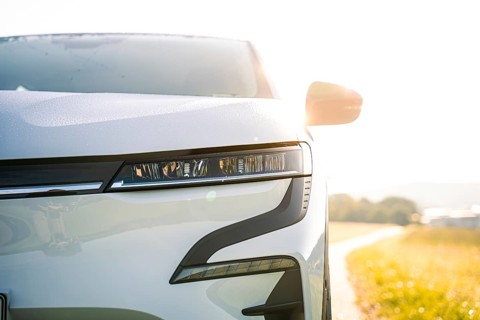 Front part of a white car with modern headlights in sunny surroundings, Deer E-Carsharing, Renault