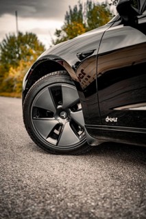 Detailed view of a car tire on a grey road surface, Deer e-car sharing, Tesla Model 3, Calw,