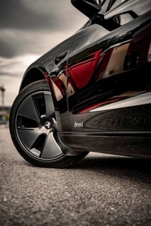 Close-up of a car tire on asphalt, reflective surface, Deer e-car sharing, Tesla Model 3, Calw,
