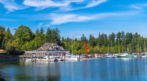 Panoramic view of the stanley park seawall with moored sailboats and yachts in coal harbour,