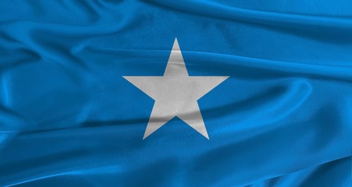 Flag of Somalia with fabric textured background. Close up of National flag of Somalia with