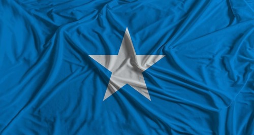 Somalia flag with fabric texture background. National flag of Somalia with cloth texture