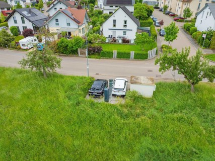Aerial view of a residential area with street surrounded by green nature, Deer E-Carsharing, Calw,